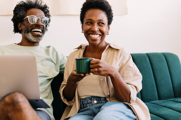 Happy mature couple relaxing on the sofa with at home
