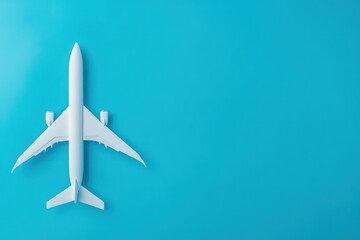 Airplane model on blue background, travel planning concept