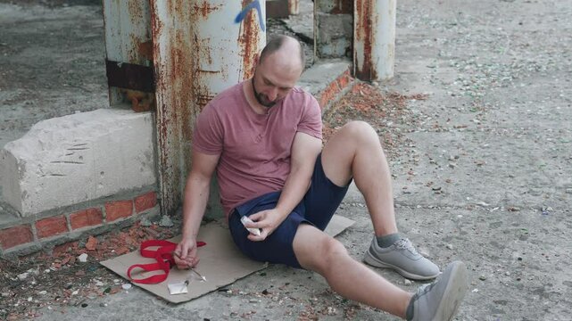 A drug addict prepares lines of heroin and fentanyl. The concept of alcohol and drug addiction.