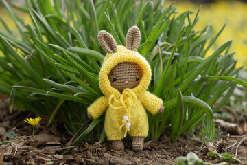 Knitted rabbit in yellow overalls
