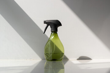Spray bottle of freshener on windowsill