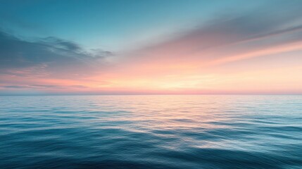 Fototapeta premium A tranquil ocean view with the sky transitioning from warm sunset hues to soft twilight tones.