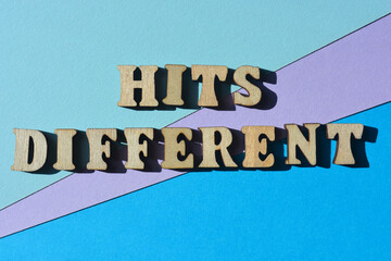 Hits different, words in wooden alphabet letters as banner headline