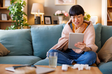 Fototapeta premium Patient consulting with online doctor while sick at home