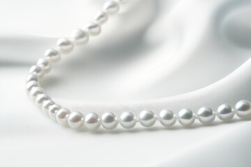 Obraz premium Elegant White Pearl Necklace on Smooth Silk Fabric Background