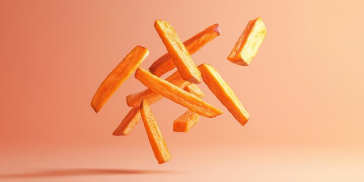 Floating sweet potato fries with dipping sauce on a soft peach background