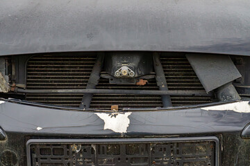 devastated front of the car. car after a road collision. scratched front bumper, paint chips....