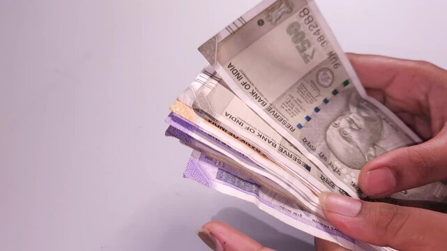 woman's hands counting Indian currency notes  Indian cash money of 500, 200 and 100 rupees