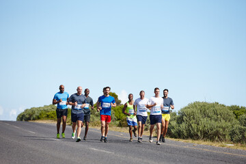 Obraz premium Group, fitness and people with running in road for marathon workout, competition training and body endurance. Blue sky mockup, men and exercise for race performance, sports challenge and club cardio