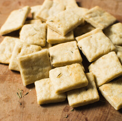 Overhead view of homemade crackers on a wood countertop, top view of freshly baked cracker biscuits, process of making crackers