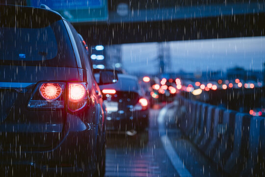Traffic jam in evening with storm raining. people stuck on heavy traffic wet rain road in Bangkok