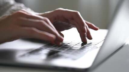 Close-up of a woman's hands typing on a keyboard using an artificial intelligence laptop chatbot - Powered by Adobe