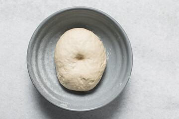 Overhead view of proofed dough, Checking if dough is proofed using a finger poke test, process of...