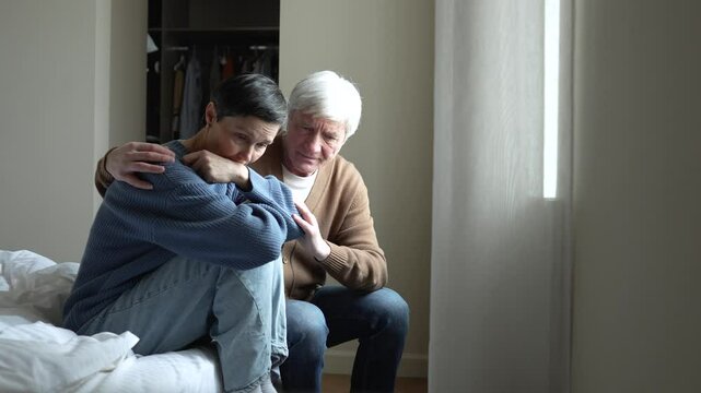 Grieving devastated woman crying while comforting husband embrace her. Wife need mental help from trouble emotional burnout, support, consolation in difficult situations in family relations