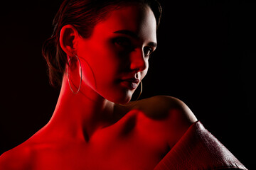 Photo of stunning hot young woman sensual model neon red light dressed leather jacket on black...
