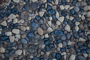 Faded dark black rock stone wall texture background. Tiled. Vintage effect.