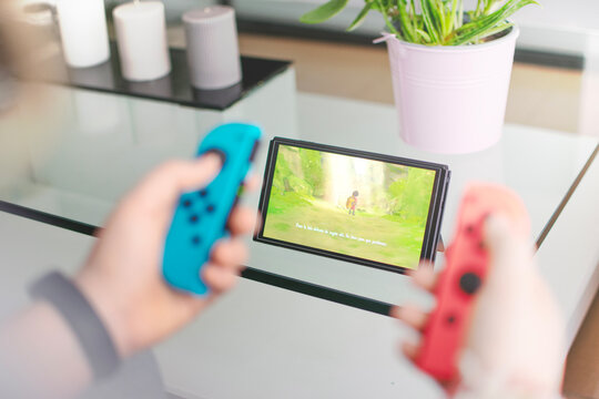 Detail of a girl playing with her Nintendo Switch video game console.