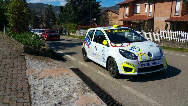 Canossa Reggio Emila, Italy : 2015 06 04 Free Salom Event White Renault Twingo R2 rally car with sponsor decals at an event, with people around.