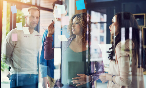 Business people, brainstorming or meeting with writing for schedule planning, strategy or tasks at office. Group, employees or graph with chart for project, agenda or company performance at workplace