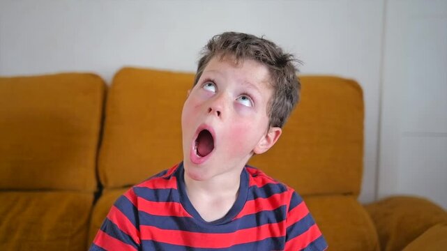 Funny moments of a child making silly faces at home