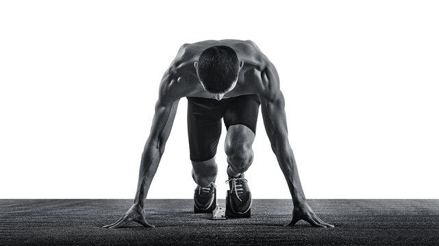 Young man, jogger, sprinter standing on start line, ready and focused, looking down against white background. Monochrome photo. Concept of sport, healthy lifestyle, championship, action. Ad