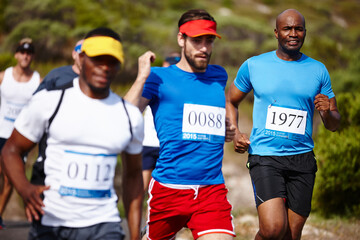 Fototapeta premium Marathon, men and running in group outdoor for fitness competition, endurance challenge and workout. Sports, runner and cardio exercise with race, performance and contest for healthy body or wellness