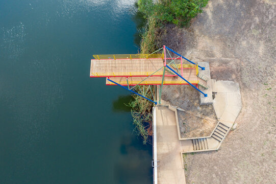Looking down on a double level diving platform over a lake