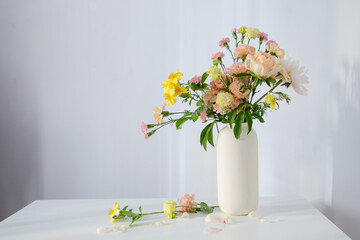 beautiful bouquet in white vase in sunlight