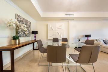 an image of a large glass dining table in luxurious mediterranean holiday home 