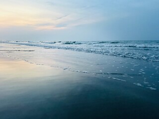 Twilights seascape, sandy beach, no people, evening sky reflection at the seashore