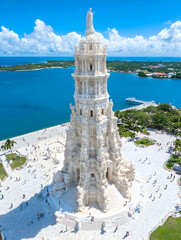 Aerial view of a large, ornate white tower by the sea.