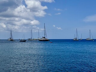 seascape of Guadeloupe in the French West Indies with a view of sailboats on a calm sea with some...