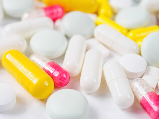 Pills of different shapes and colors on a spectacular background: an illustration of...