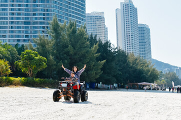 Asian kid and mom riding ATV at in Xunliao Bay, Huizhou city, Guangdong Province, China, during January © sweetriver