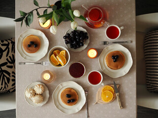Hygge breakfast. Pancakes, fruits, tea. Cozy Morning
