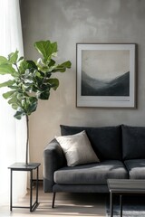Modern living room interior design with a potted plant, sofa, and art piece on the wall.