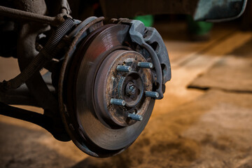 Close-up View of Rusty Car Brake Rotor and Caliper During Maintenance or Repair