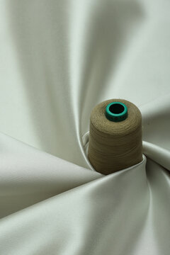 Top down view of pastel green, luxurious, twirled, flat lay, brocade fabric with satin finish.