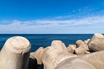 tranquil seascape with tetrapods and sea horizon