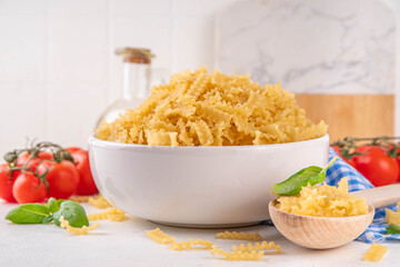 Raw Mafaldine pasta with ingredient for cooking