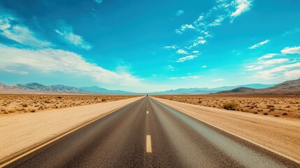 Naklejka premium A long, empty road stretches across a desert landscape