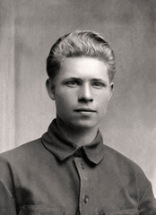 Vintage photo of a young man in a tunic. Photo from 1934