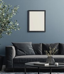 Modern living room interior with dark gray sofa, coffee table, plant, and framed poster.