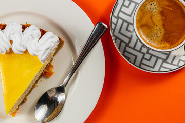 Enjoying a delightful slice of cake alongside a steaming cup of coffee