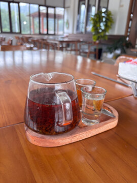 tea kettle, liquid sugar, and glass cups to enjoy tea during the day