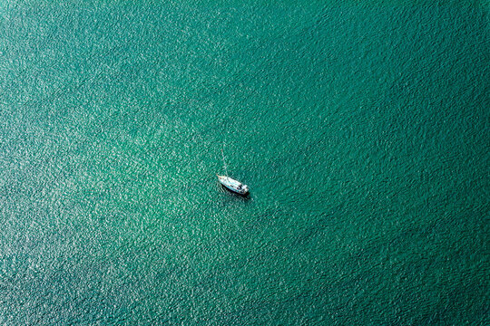 white boat moored in sea green water