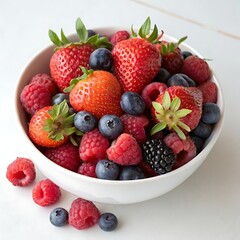 Obraz premium Bowl of mixed berries with strawberries and blueberries