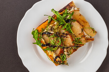 Delightful savory flatbread with pear and arugula enjoyed in a cozy setting