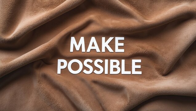 Close-up of textured brown fabric with inspirational motivational quote overlayed in bold letters