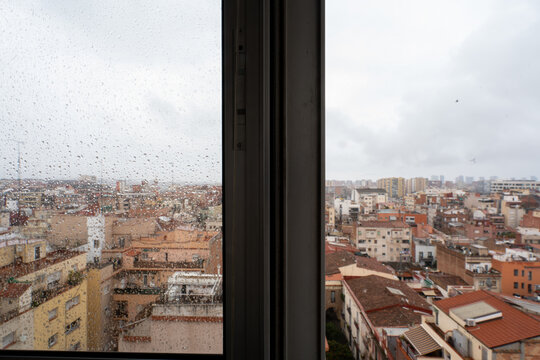 View through the rain-soaked window, Barcelona city skyline view